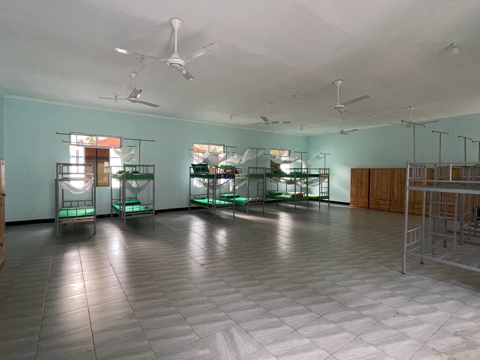 Boarding dormitory with bunk beds and mosquito nets